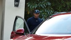 Tiger Woods heading into a car after withdrawing from the 2024 Genesis Invitational