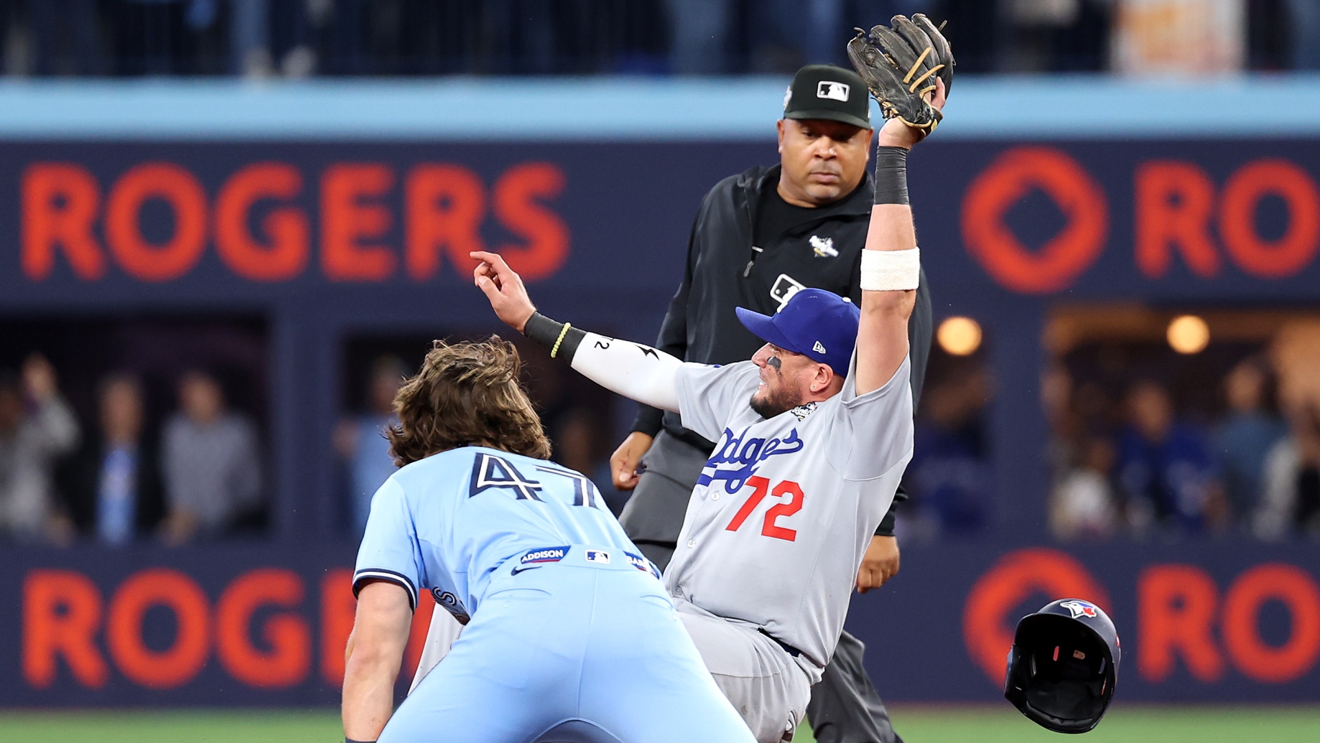 The Los Angeles Dodgers' Miguel Rojas forces out the Toronto Blue Jays' Addison Barger in the 2025 World Series at Rogers Center