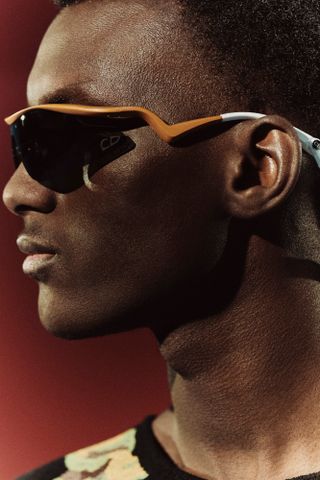 Close up of man in sporty wraparound sunglasses by Dior