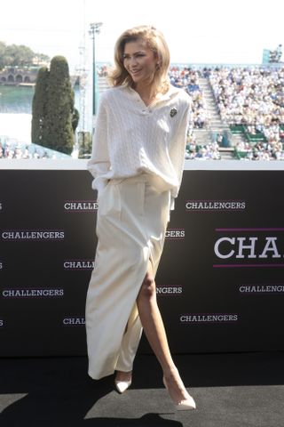 Zendaya wears a cable knit sweater and long white skirt at a Challengers appearance in Monaco