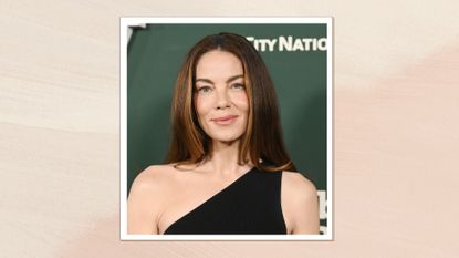 Michelle Monaghan is pictured with glowing skin and wearing a black, one-shoulder dress at the 2023 Baby2Baby Gala held on November 11, 2023, in Los Angeles, California/ in a peach and cream watercolour paint-style template