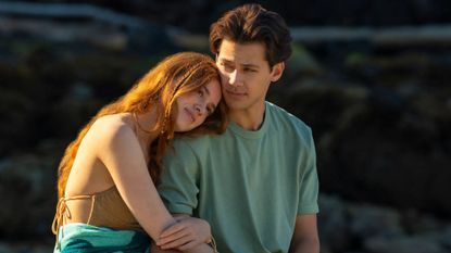 A young couple embrace on the beach