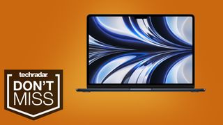 MacBook Air M2 on an orange background with TechRadar's Don't Miss badge