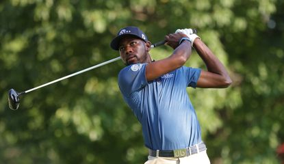 Kamaiu Johnson watches his tee shot after hitting a driver