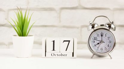 calendar showing October 17 next to an alarm clock