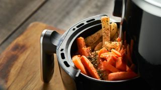 An air fryer filled with seasoned vegetables