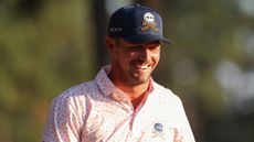 Bryson DeChambeau smiles while looking down during round three of the 2024 US Open