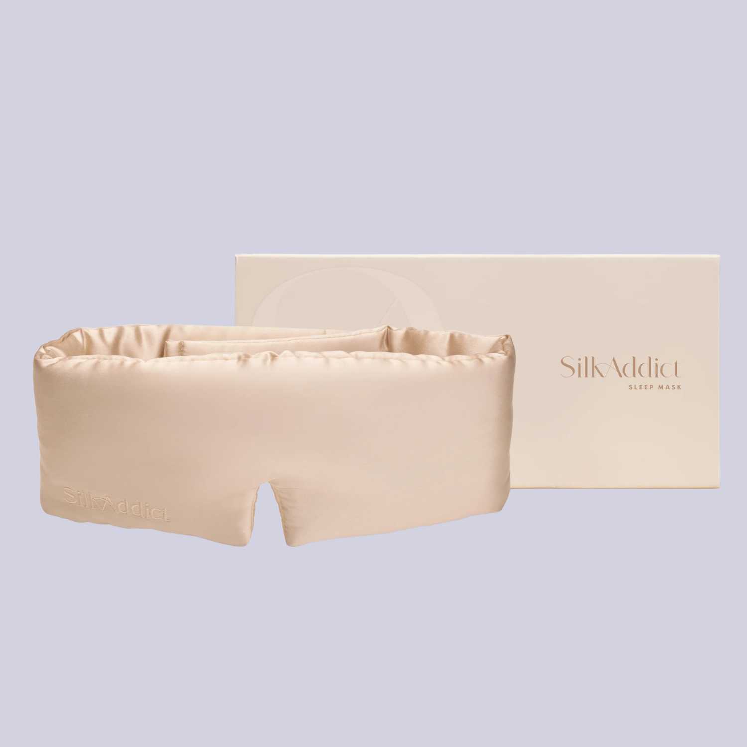 A cream silk sleep mask