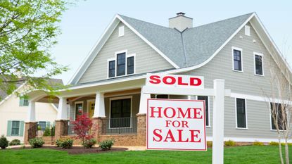 picture of house with sold sign in front yard