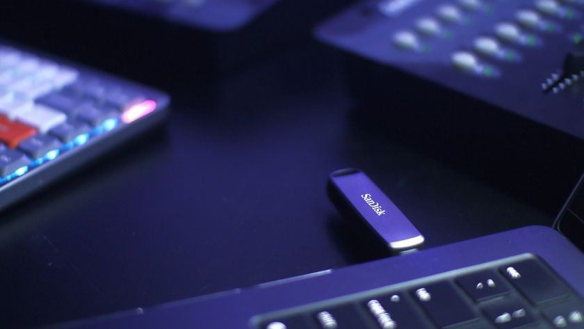 A promotional photograph of a Sandisk USB flash drive protruding from a laptop.