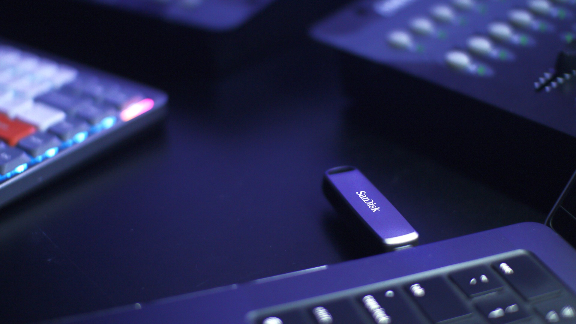 A promotional photograph of a Sandisk USB flash drive protruding from a laptop.