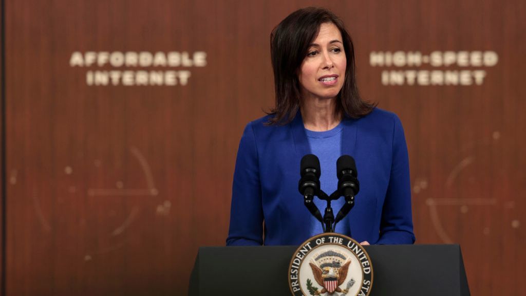 Jessica Rosenworcel stands before a presidential podium, dressed in a blue suit with the blurred words &amp;#039;Affordable Internet&amp;#039; and &amp;#039;High Speed Internet&amp;#039; in the background