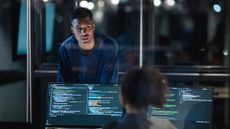 Two cybersecurity professionals in a modern office.