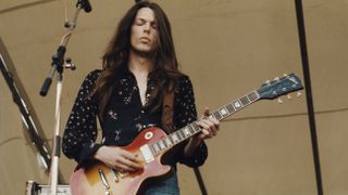 American guitarist Scott Gorham performs playing a Gibson Les Paul guitar on stage with Irish rock group Thin Lizzy at the Reading Festival, 24th August 1974
