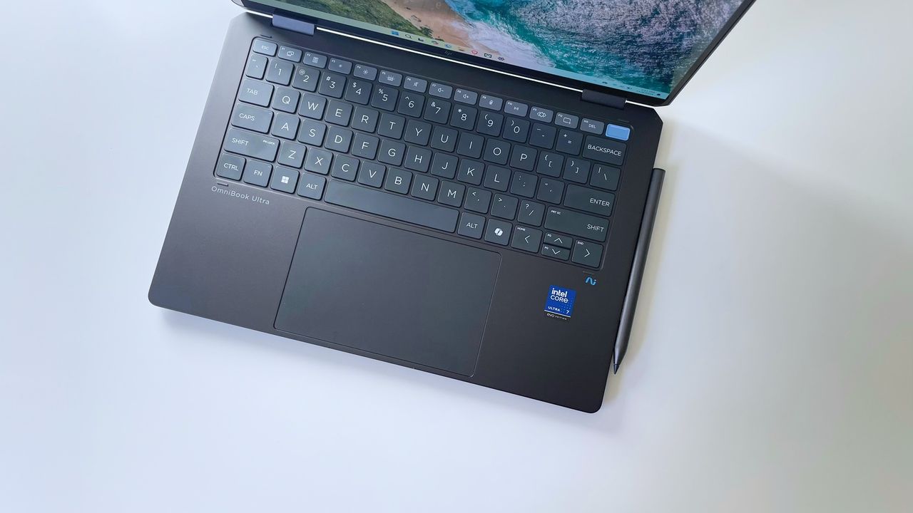 A laptop keyboard and trackpad viewed from above on top of a white surface.