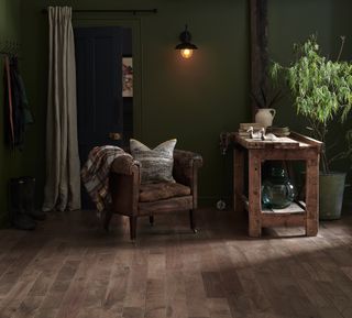 dark herringbone solid wood flooring with dark green walls