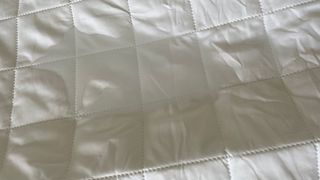 OTTY Waterproof Mattress Protector with a water puddle on it