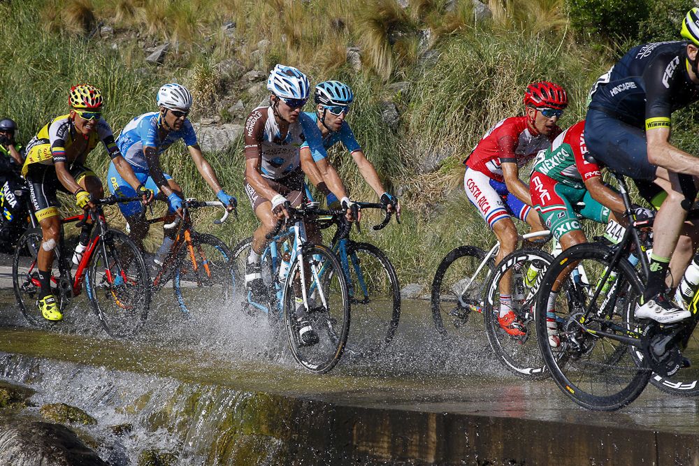 Riders make their way through a wet patch during stage 6.