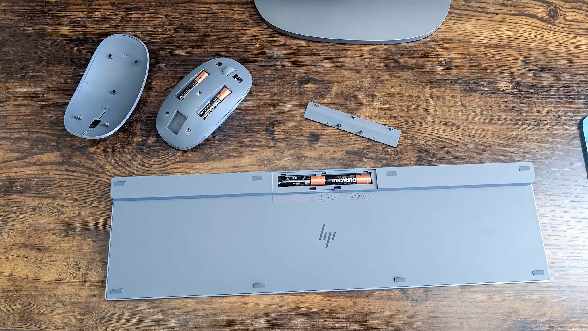 Image showing mouse cover and keyboard cover removed to insert batteries. 