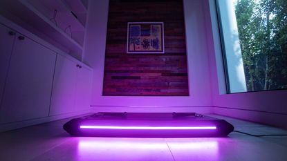 Vitruvian V-Form Trainer reviewL Pictured here, the trainer lit up in purple in a living room
