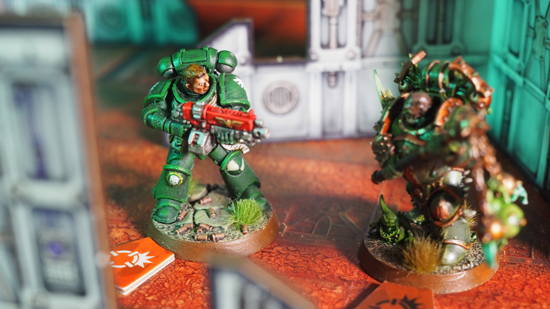 A Space Marine faces down a Plague Marine amidst a ruined battlefield