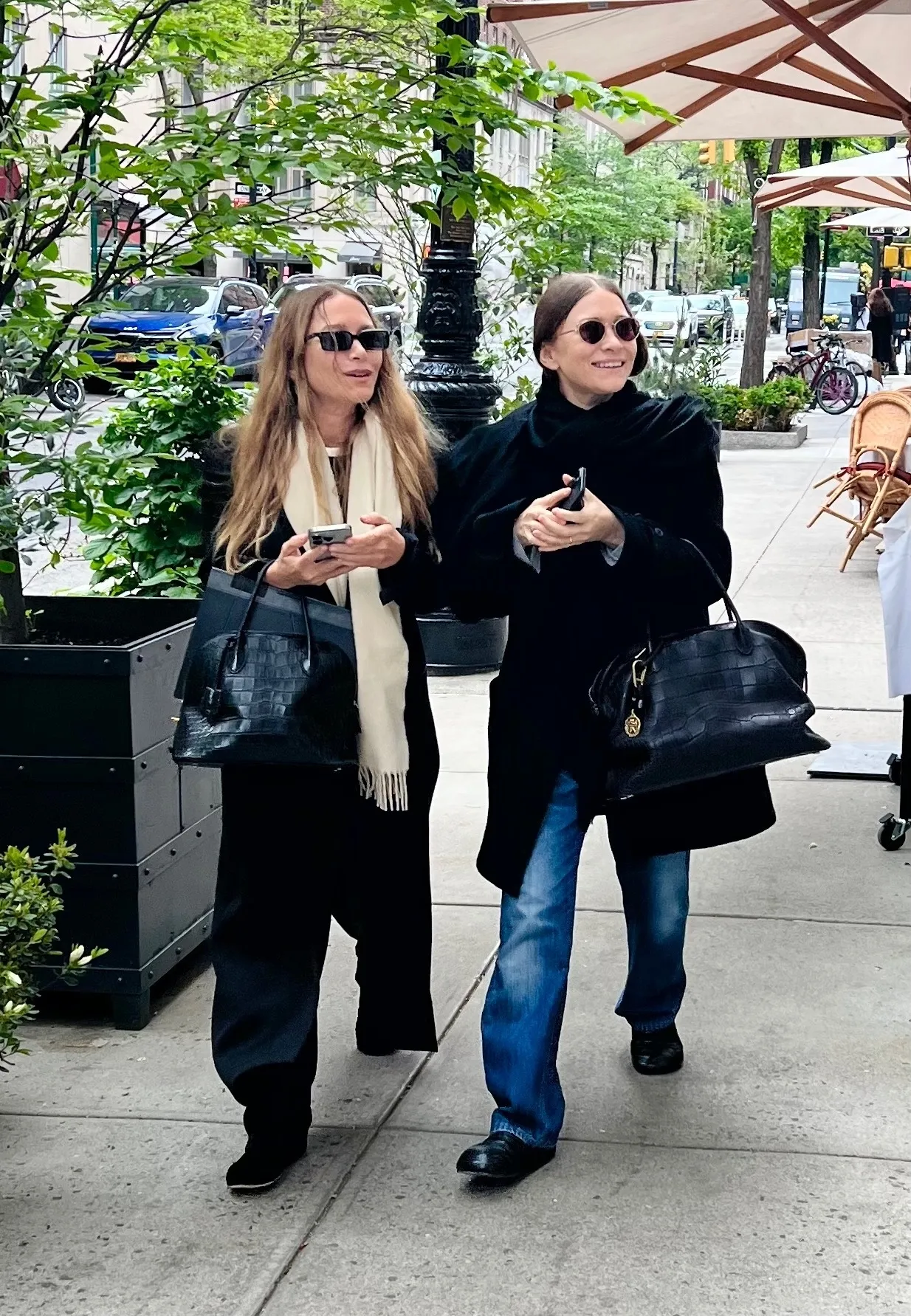 Mary-Kate and Ashley Olsen wear The Row Agnes bag.