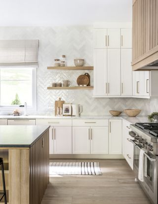white kitchen with zellige backsplash and wood island by Lindye Galloway