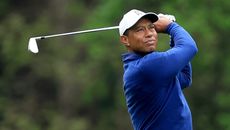 Tiger Woods hits an iron shot