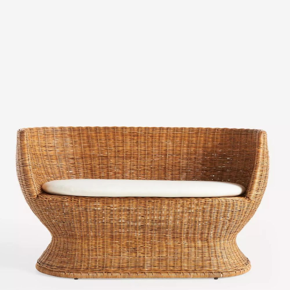 Rattan sofa with curved edges and flared base