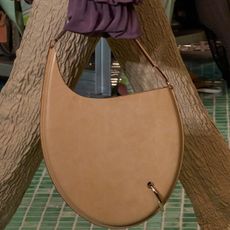 Two pierced handbags from Tory Burch's S/S 25 runway show. 