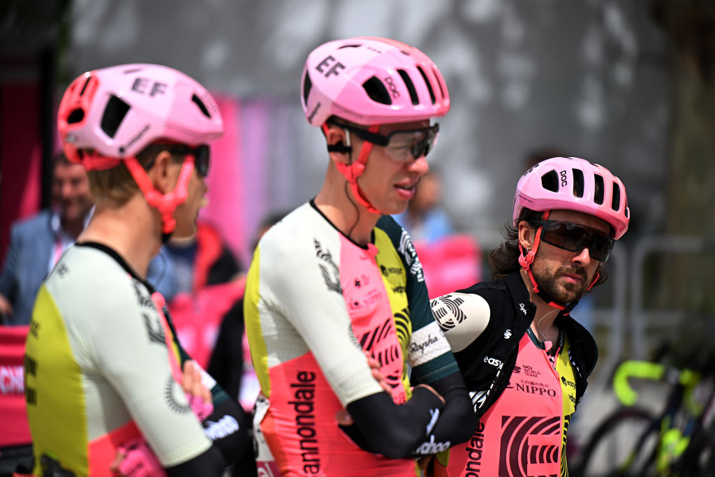 men in lycra stand talking