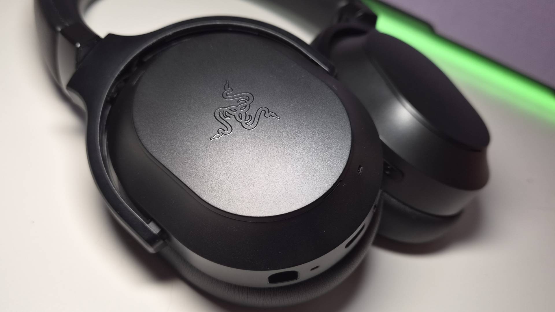 Photo of the Razer Barracuda V2 Pro headset sitting on a white desk.