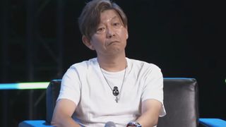 Naoki Yoshida with a deadpan expression as he recounts a childhood story on stage at PAX West.