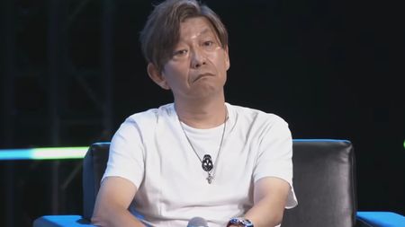 Naoki Yoshida with a deadpan expression as he recounts a childhood story on stage at PAX West. 