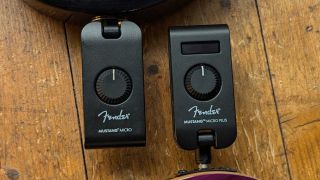 A Fender Mustang Micro and Mustang Micro Plus side by side on a wooden floor