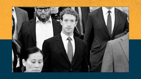 A man in a suit, surrounded by others, leaves a court building. 