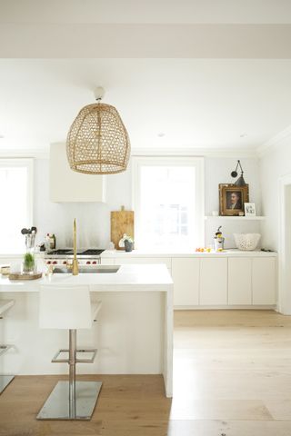 White kitchen with no wall cabinets designed by Lisa Sherry