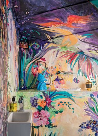 a bold mural painted in a small bathroom