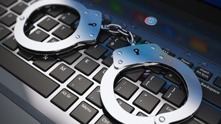 metal handcuffs on laptop keyboard
