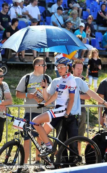 Julie Bresset keeps out of the sun before the start