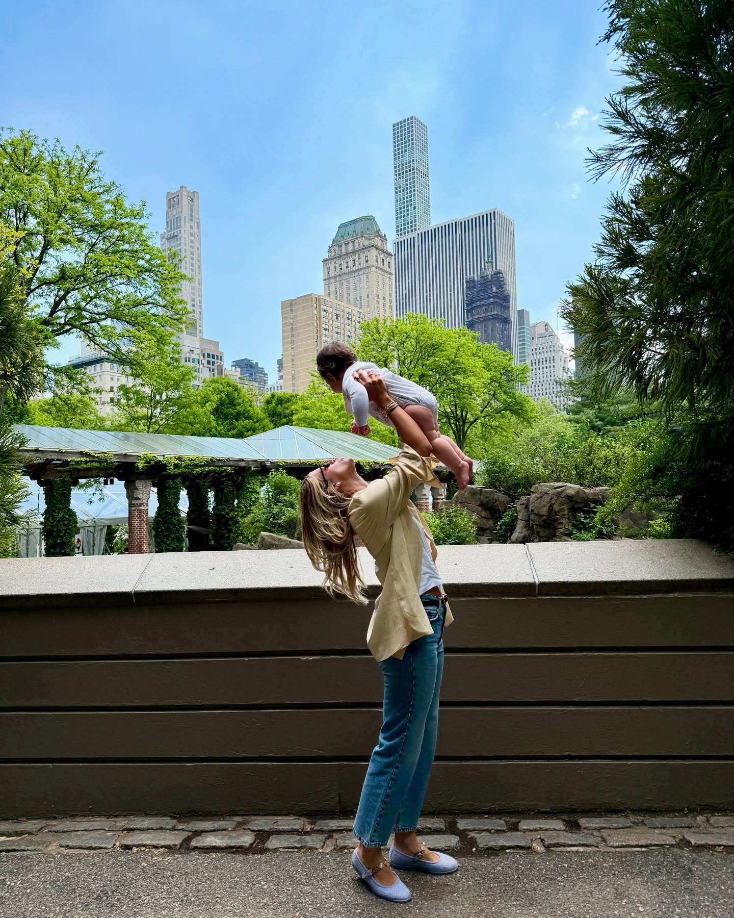 Sofia wears a yellow top, blue jeans, and lavendar ballet flats.