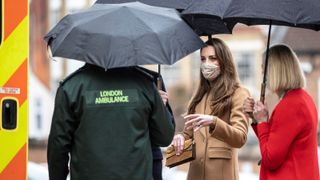 Kate Middleton's kind gesture, Britain's Prince William, Duke of Cambridge (hidden) and Britain's Catherine, Duchess of Cambridge (2R), both wearing face coverings due to Covid-19, talk with members of the ambulance service in the wellbeing garden during a visit to Newham Ambulance Station in east London on March 18, 2021