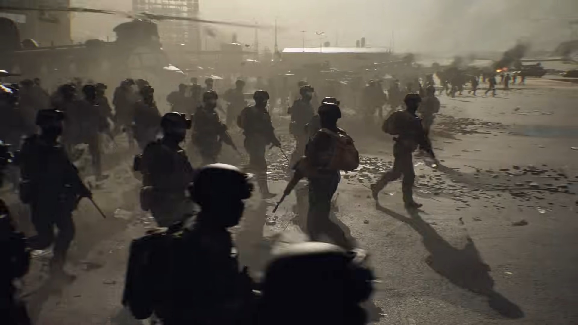 Troops move out of helicopters, as fires burn in the background