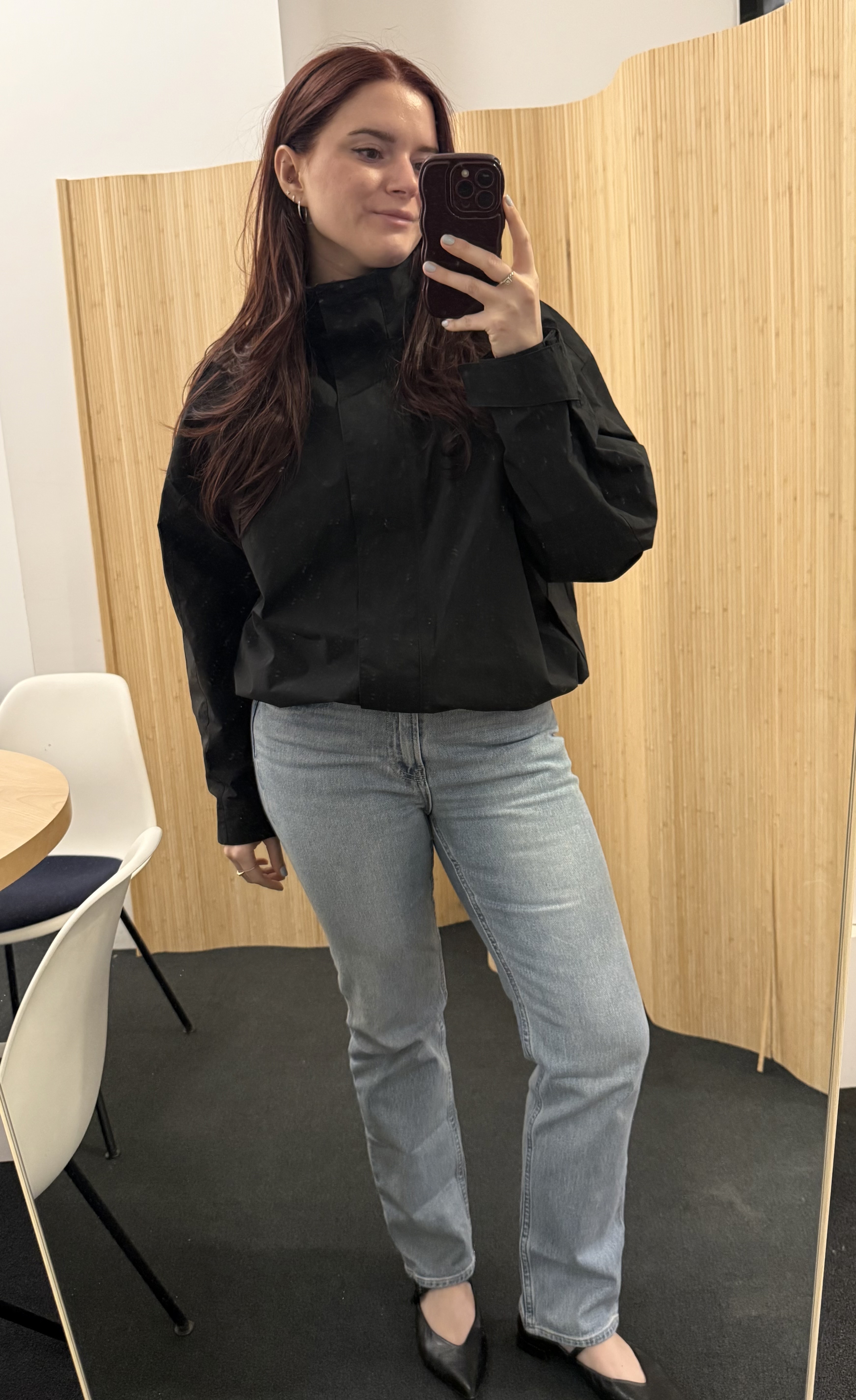 Brooke Knappenberger poses in mirror wearing black jacket and gap jeans