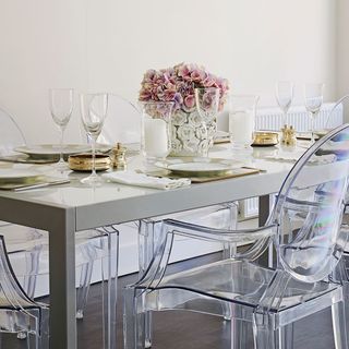 modern dining table with chairs and wine glasses