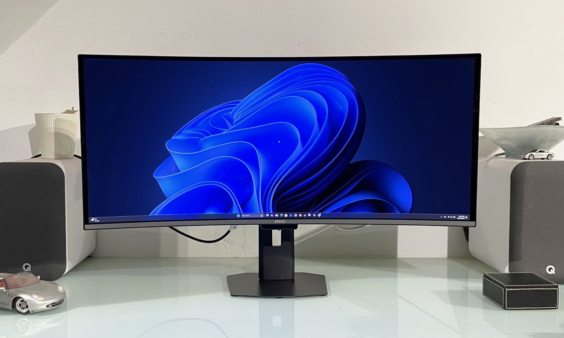 The MSI MPG 341CQR QD-OLED X36 monitor on a desk in a light room