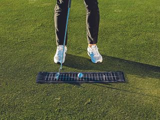 Gary Munro using a putting mat to work on his putting stroke