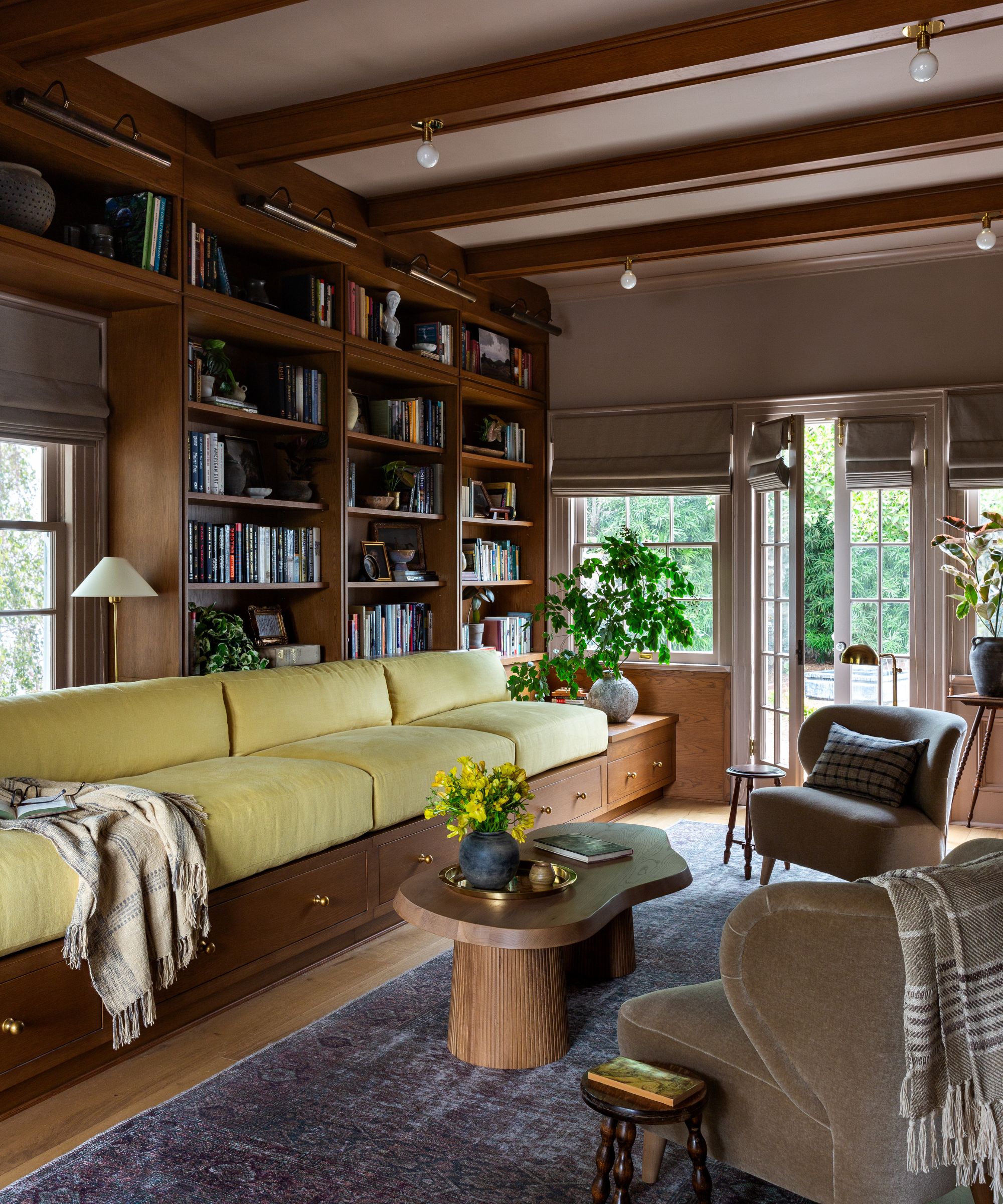 Library and games room with custom millwork and deep bench seating by Plaster &amp;amp; Patina, Photograph Amy Bartlam