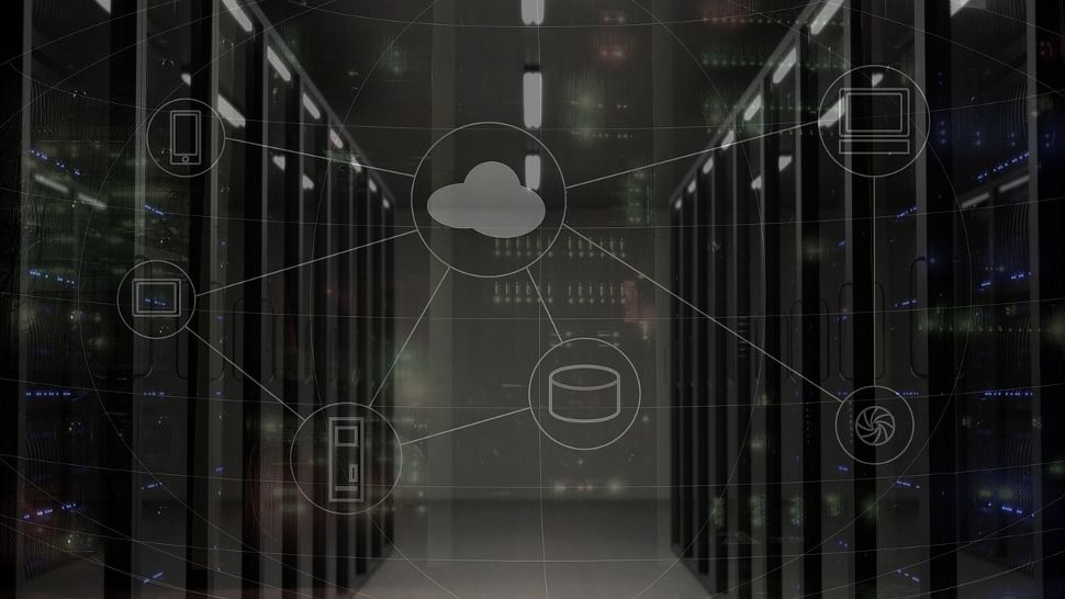 A cloud symbol imposed over a bank of servers in a data center.