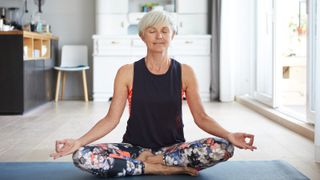 woman with legs crossed doing breathing yoga pose